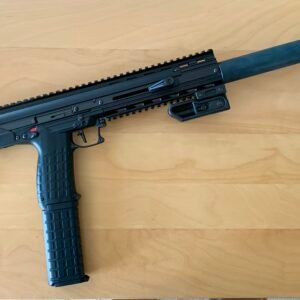A Keltec CMR30 .22WMR Custom Over-Barrel Moderator with a folding stock, suppressor, rail system, and angled foregrip rests on a light wood surface.