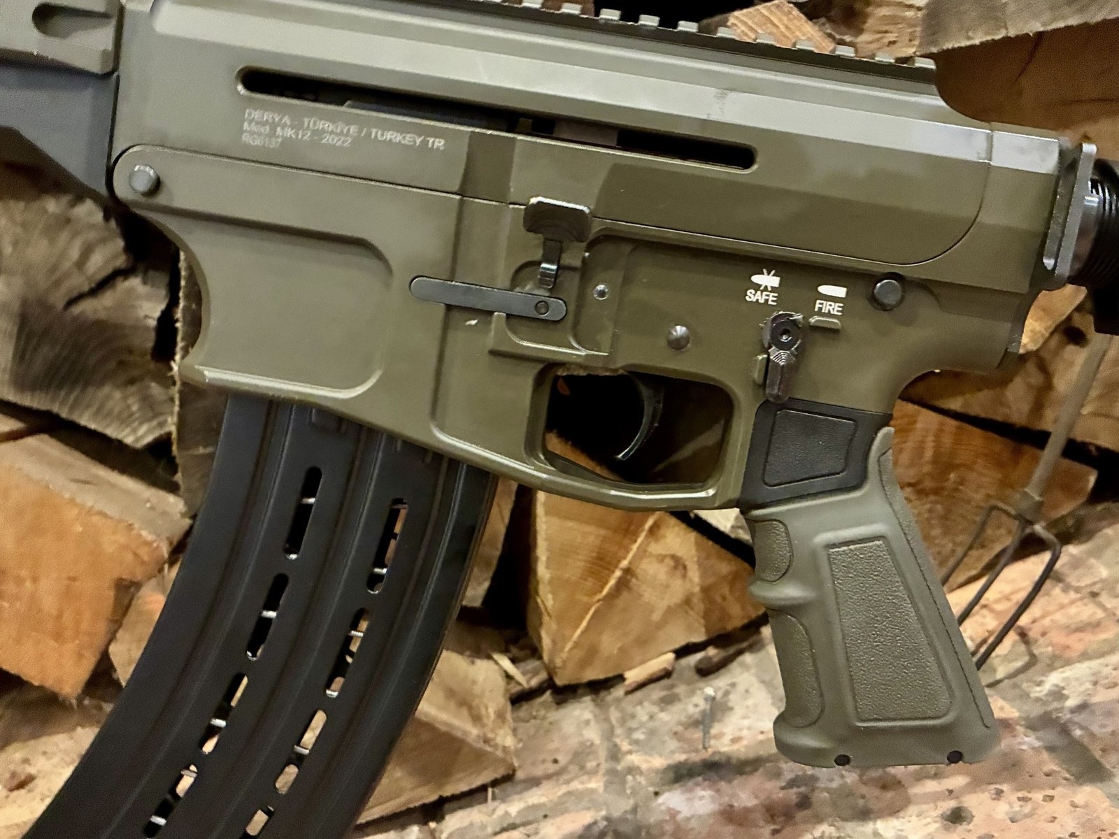 Close-up of the left side of a Derya Mk12 12G Semi-Automatic Section 1 (FAC) Shotgun in OD Green