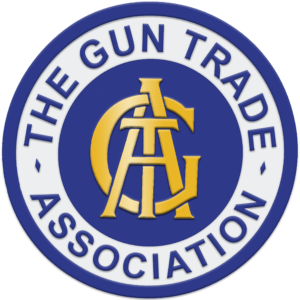 A blue and white circular logo with gold overlapping letters GTA in the centre and the words THE GUN TRADE ASSOCIATION around the edge.