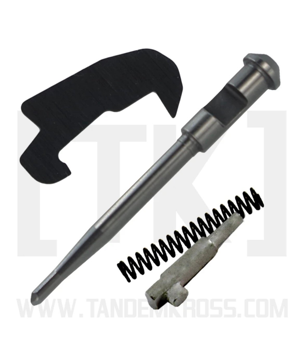 Components of the Volquartsen Essential Upgrade & Maintenance Kit for the Smith & Wesson M&P 15-22, including a metallic firing pin, a coil spring, a small metal part, and a flat black plate.